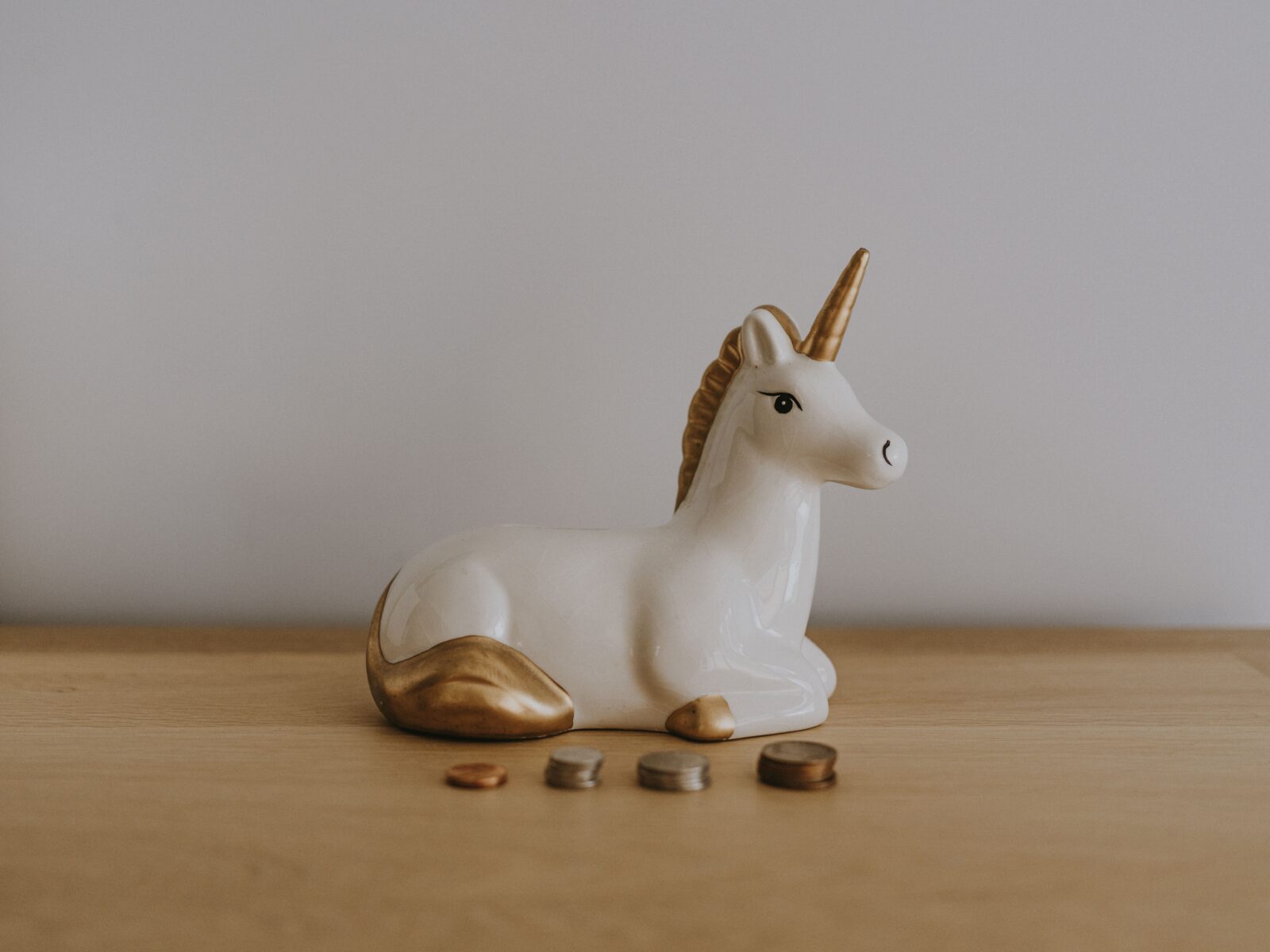 China unicorn ornament with different piles of coins